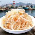 Chilled shredded jellyfish salad served in a white bowl