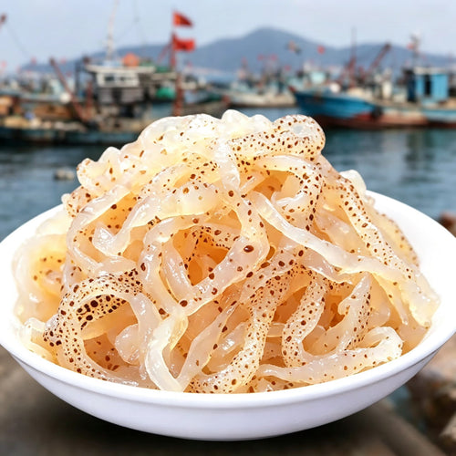 Chilled shredded jellyfish salad served in a white bowl