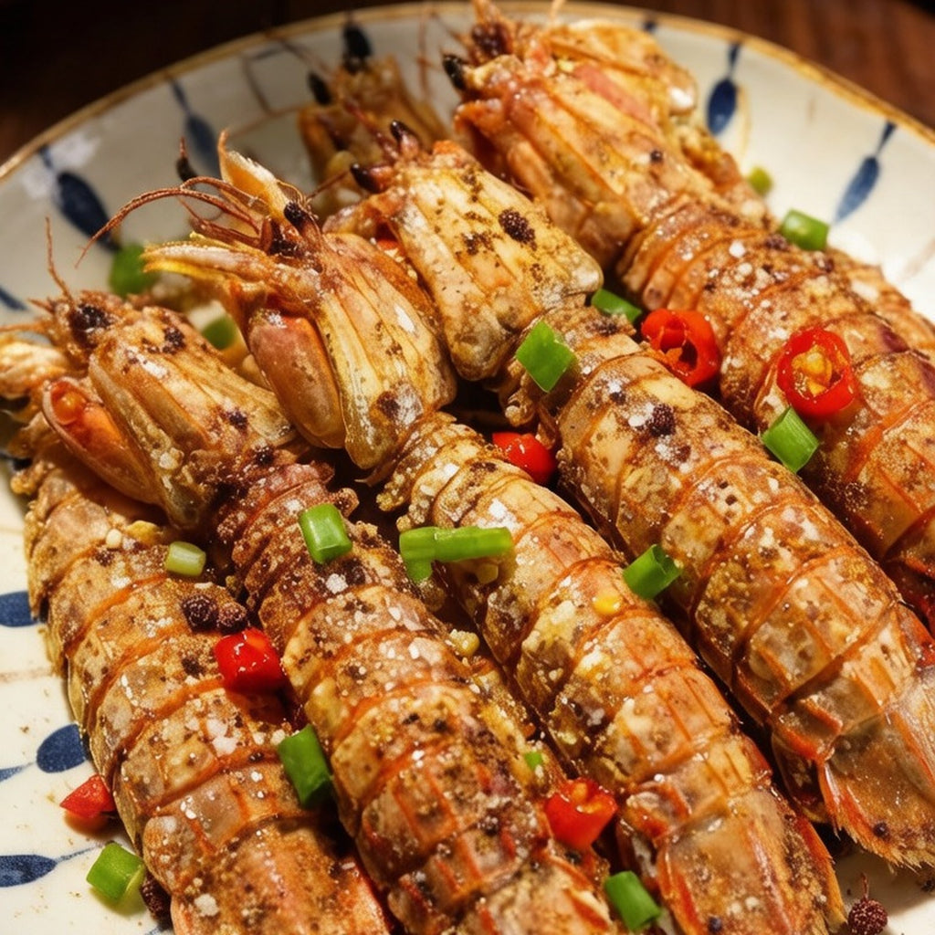 Salt and pepper mantis shrimps tossed with chilli and scallion on a patterned plate