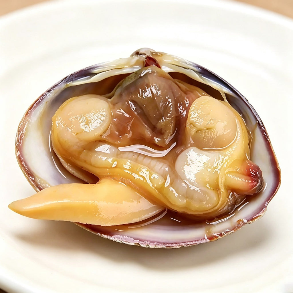 A single opened clam showing plump meat on a ceramic dish
